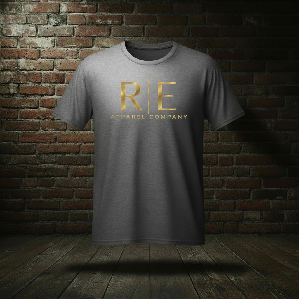 Rogue Standard Gold Tee in Ash on a ghost form against a dark brick wall and wood floor