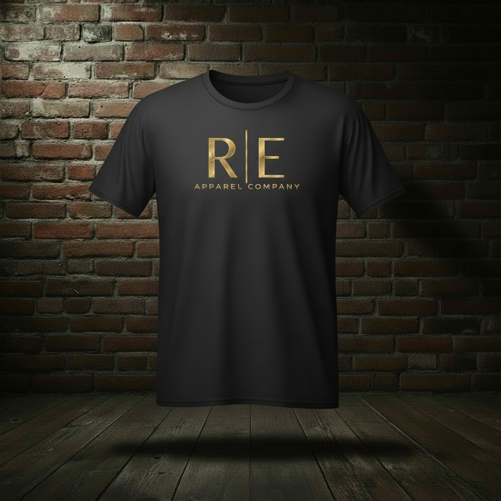 Rogue Standard Gold Tee in Jet Black on a ghost form against a dark brick wall and wood floor