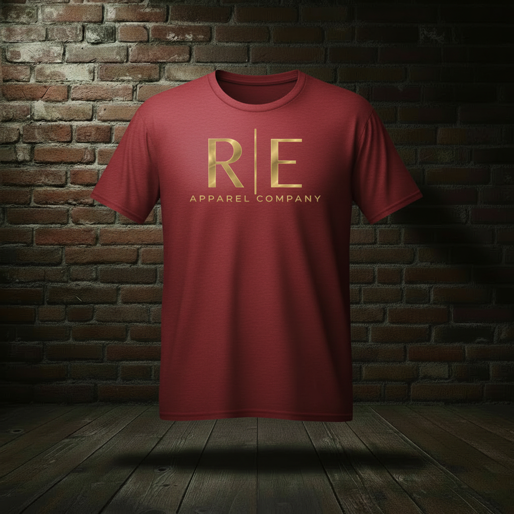 Rogue Standard Gold Tee in Cardinal on a ghost form against a dark brick wall and wood floor