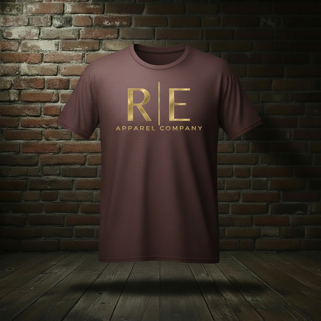 Rogue Standard Gold Tee in Athletic Maroon on a ghost form against a dark brick wall and wood floor