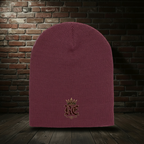 Maroon RE Crest knit hat on a dark red-and-black brick boutique background